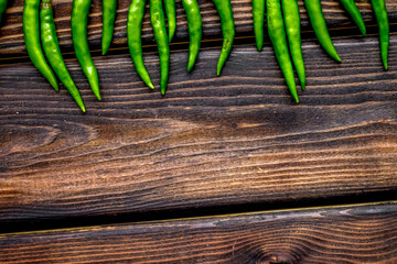 Wall Mural - Fresh green chilli pepper as food ingredient on wooden table background top view mockup