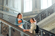 © Valerii Apetroaiei - Students chatting on a university stairway, soaking up the sun and historic ambiance