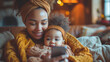 © GoodandEvil - Smiling mother and baby with a mobile phone