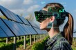 © AiHRG Design - A woman wearing augmented reality goggles inspects a solar panel farm, displaying data overlays.