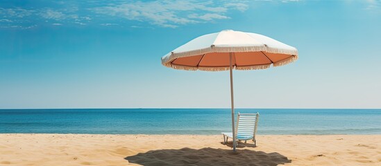 Poster - recreation concept beach umbrella lying on sandy beach. Creative banner. Copyspace image