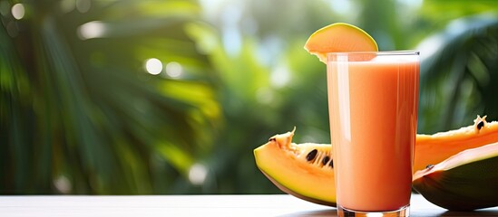 Poster - Tropical exotic papaya fruit and glass with smoothie shake juice drink outdoors with palm leaves. Creative banner. Copyspace image