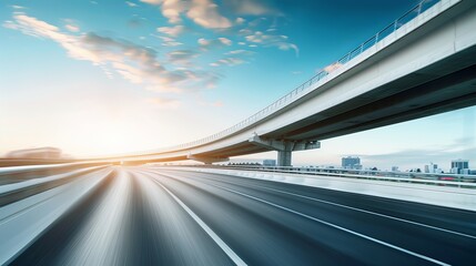 A motion blur shot of a highway overpass with a city background.