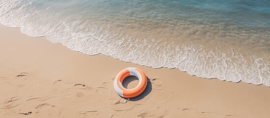 Poster - Aerial view of lifebuoy on sandy beach Summer and travel concept Minimalism. Creative banner. Copyspace image