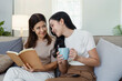 © itchaznong - Heartwarming Mother-Daughter Moment on Mother's Day - Celebrating Love and Bond with a Cozy Reading Session and Coffee