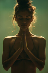 Aufkleber - Elegant silhouette of a woman in a yoga pose on a muted green gradient background,