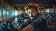 © AS Photo Family - Fit Young Man in Sportswear Working Out on a Stationary Bike in the Gym