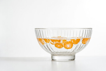 Wall Mural - Glass Bowl with Orange Slices in Water