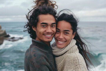 Wall Mural - Portrait of a glad mixed race couple in their 20s wearing a cozy sweater in serene seaside background