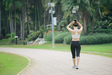 Poster - asian woman jogger running in green nature public park.