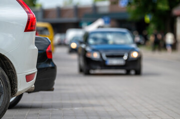 Wall Mural - White car parked on city street. Shallow depth of feld