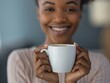 © Philipp - Beautiful and happy Black woman with curly hair, smiling warmly as she holds a cup of coffee in both hands. Mockup Concept.
