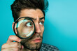 © Shutter2U - A man looking through a magnifying glass, highlights curiosity and discovery, with copy space