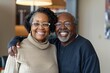 © Markus Schröder - Portrait of a happy afro-american couple in their 70s sporting a long-sleeved thermal undershirt over sophisticated corporate office background