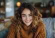 © olegganko - Smiling Woman With Curly Hair Wearing a Brown Sweater