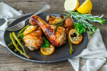 Wall Mural - Lemon chicken drimsticks with baked potatoes and asparagus