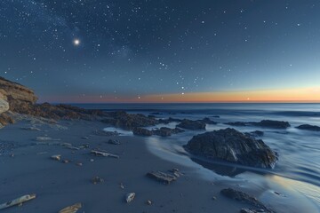 Aufkleber - A serene ocean view at night with a rocky beach in the foreground
