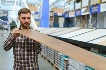 Wall Mural - Portrait of happy mature man standing in hardware store