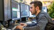 © Wolfilser - A man works as an operator specialist in a computer data center in front of many monitors with charts and data