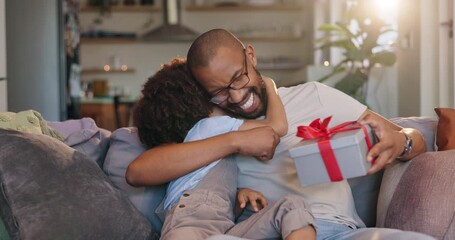 Wall Mural - Happy dad, child and hug with gift on sofa for fathers day surprise, love or gratitude at home. Papa with smile for ribbon present or box on living room couch with son, little boy or kid at house