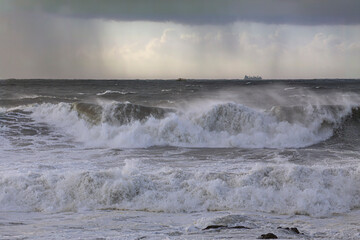 Wall Mural - Stormy breaking waves in a rainy evening