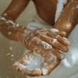 © kittipoj - Hydrating Skin Care Routine - Close-up of Woman's Hands Applying Lotion to Arms