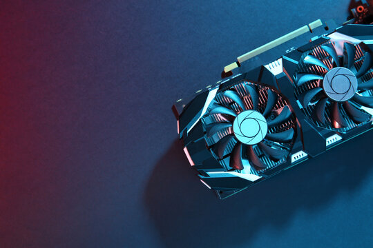 Computer graphics card on color background, top view. Space for text