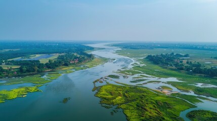 Aufkleber - A serene river flows through the heart of a lush green countryside, offering a peaceful atmosphere