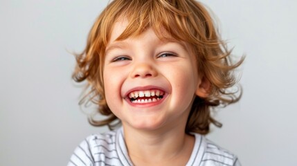 Wall Mural - A young boy smiles while holding a toothbrush in his mouth, a fun and playful scene