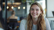 © RealityForge - Portrait of a young gen-z woman with blonde hair  smiling confidently at a job interview at a tech company.