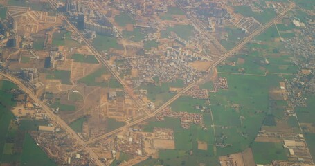 Poster - Delhi, India. View From Airplane Window On View of the Delhi suburbs. High-rise buildings are adjacent to logistics bases. Sleeping quarters of new high-rise buildings against the backdrop of a green