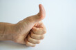 © Mila - male hand showing thumbs up on white background close up