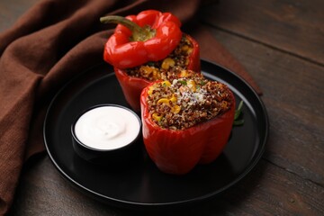 Wall Mural - Quinoa stuffed peppers with corn and sauce on wooden table