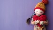 © AI Stock House - Doll holding a textile red heart on a purple background