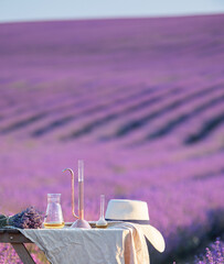 Wall Mural - Amber essential lavender oil bottle. Violet lavendar field in Provence.