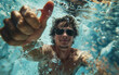© bluebeat76 - Young man wearing sunglasses swimming underwater giving thumbs up sign