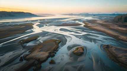 Wall Mural - An aerial view of the river delta at Nisqually Wildlife Refuge at low tide at sunset