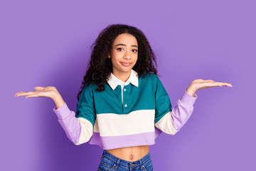 Wall Mural - Photo of nice young girl shrug shoulders wear shirt isolated on violet color background