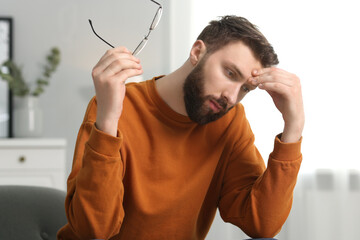 Wall Mural - Overwhelmed man with glasses suffering at home