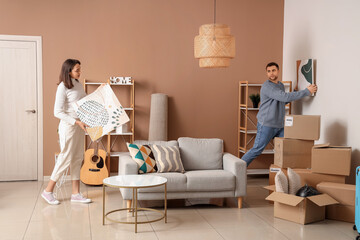 Sticker - Happy young couple with paintings in room on moving day