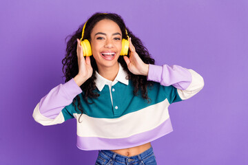photo of nice young girl touch headphones wear shirt isolated on violet color background