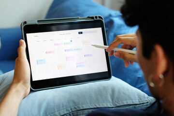 Man holding digital tablet with timeline project schedule, work plan mangement