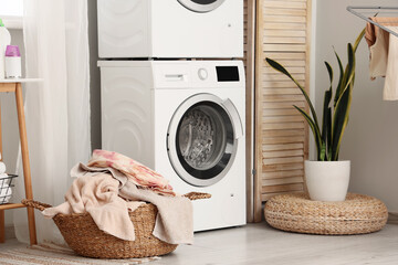 Sticker - Laundry basket near washing machines in room