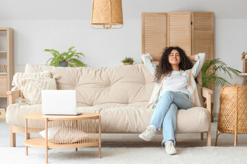 Poster - Young African-American woman resting on couch at home