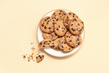 Wall Mural - plate of sweet cookies with chocolate chips on beige background