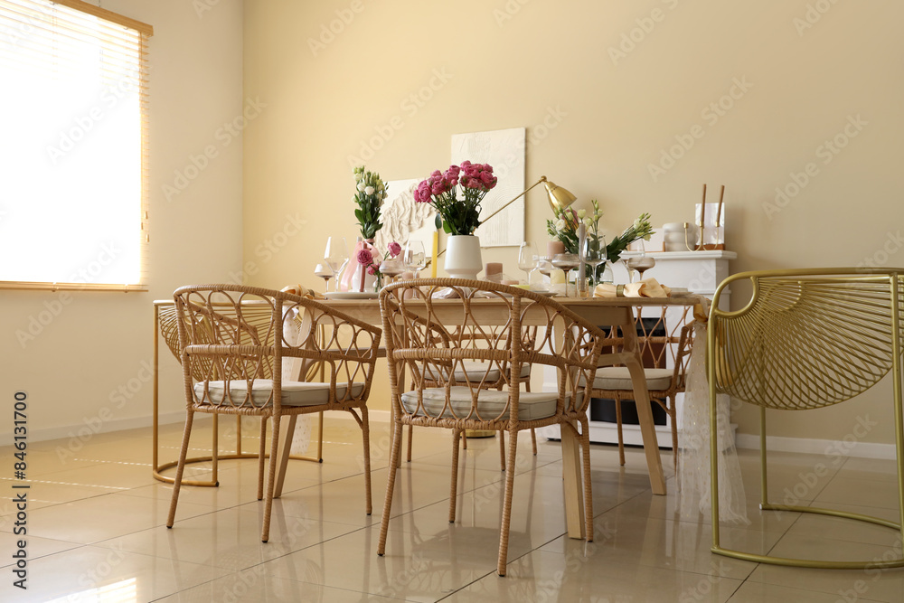 Beautiful table setting with flowers and candles for wedding celebration in room