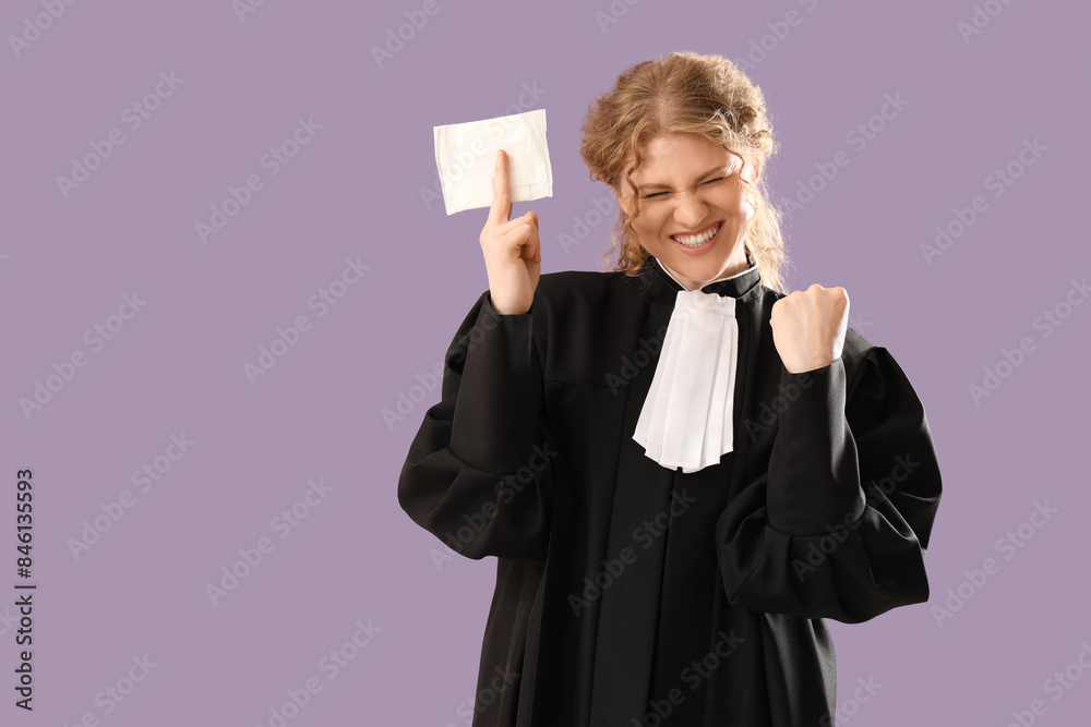 Happy female judge with menstrual pad on violet background
