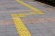 © upen - Installation of guiding block patterns for safe turning, enhancing accessibility and navigation for visually impaired pedestrians