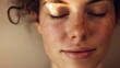 © Ilia Nesolenyi - A close-up portrait of a woman with closed eyes, showcasing her serene expression and radiating inner peace