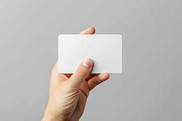 Hand holding a blank white credit card mockup with rounded corners, ideal for financial or payment-related concepts and designs